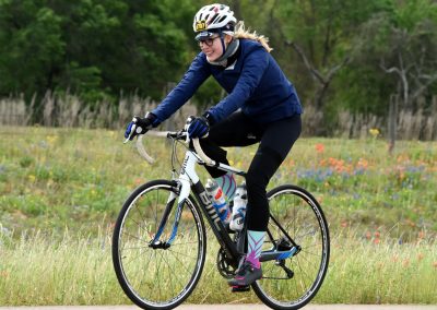 Vibrant cyclist riding mountain bike on scenic trail in the countryside.