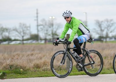 Bright green cycling jacket and black bike helmet for Bluebonnet Express biking event.
