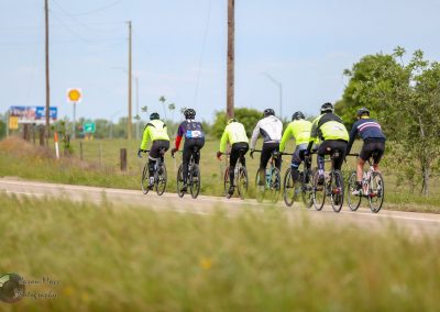 Cyclists riding together on a scenic bike trail for Bluebonnet Express event.
