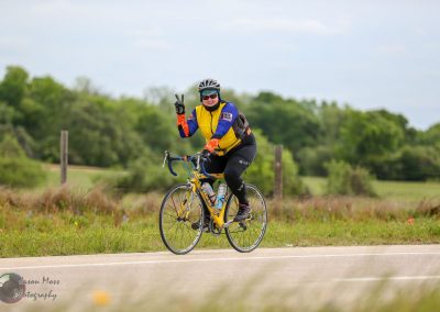 Colorful cyclist enjoying a scenic bike ride on Bluebonnet Express trail in Texas.