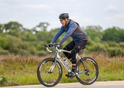 High-performance cyclist riding a Specialized bicycle on outdoor trail during daytime.