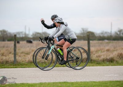 Riders enjoying a scenic bike ride on the Bluebonnet Express trail in Texas, promoting outdoor fitness and community cycling.