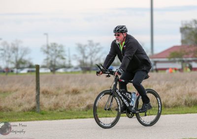 Cyclist riding a bike outdoors, focusing on Bluebonnet Express cycling event.