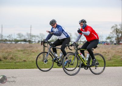 Police officers cycling outdoors during a community event, promoting fitness and public safety.