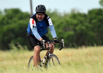 Vibrant cyclist riding on a scenic outdoor trail during daytime, emphasizing adventure and eco-friendly transportation.