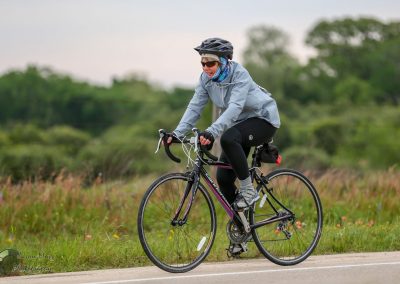 Comfortable women's bike ride on scenic trail with Bluebonnet Express, showcasing eco-friendly cycling adventures.