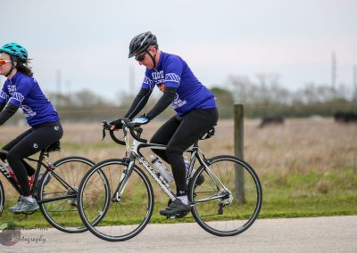 Bright blue cyclist jerseys with "Bluebonnet Express" logo for scenic bike rides and charity cycling events.
