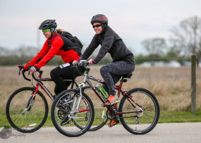 Bike ride at Bluebonnet Express with women cyclists in outdoor landscape, active lifestyle, cycling event, Texas scenery.