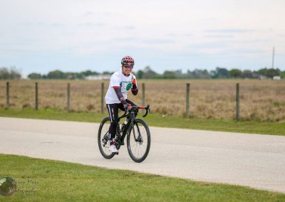 Cyclist riding a road bike on a scenic countryside route during the Bluebonnet Express event.