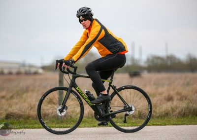 High-performance electric bike rider on a Specialized bicycle during cloudy weather.