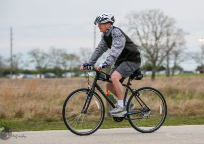 Safe cyclist riding on recreational bike trail - Bluebonnet Express cycling event.