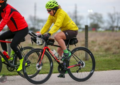 Bright yellow helmet and jacket on a cyclist during Bluebonnet Express bike race.