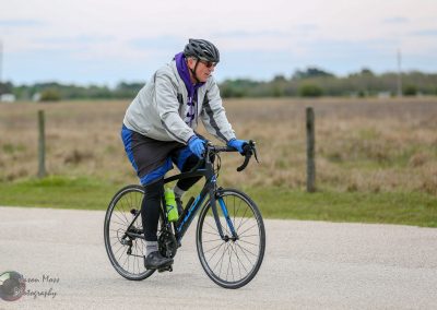 Comfortable cyclist riding Bluebonnet Express bike on scenic trail for outdoor cycling adventure.