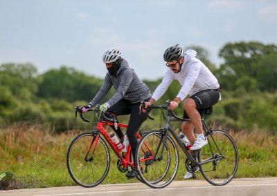 High-performance cyclists riding bikes outdoors during daytime.