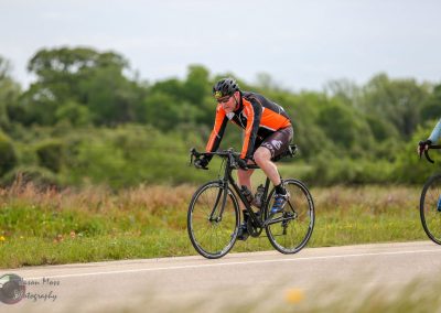 Vibrant cyclist riding on scenic trail during Bluebonnet Express event in Texas.