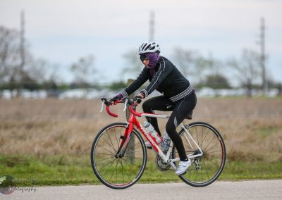 Bright red and white road bike during daytime outdoor cycling event.