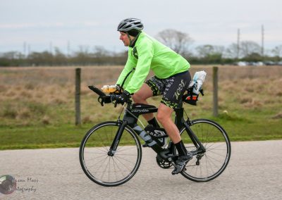 Bike riding in scenic outdoor setting with hydration bottles and athletic gear.