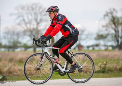 High-performance cyclist riding a Trek road bike on scenic outdoor trail in Texas.