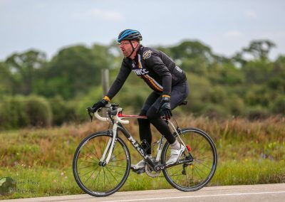 High-performance cyclist riding a road bike outdoors.