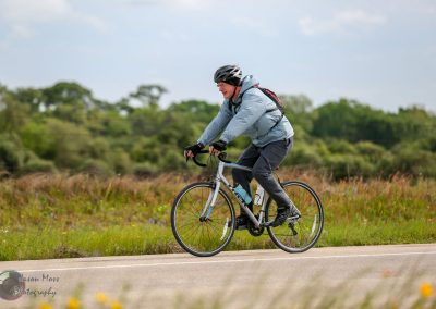 Smooth-riding cyclist on Bluebonnet Express bike trail in nature, enjoying outdoor biking adventure.
