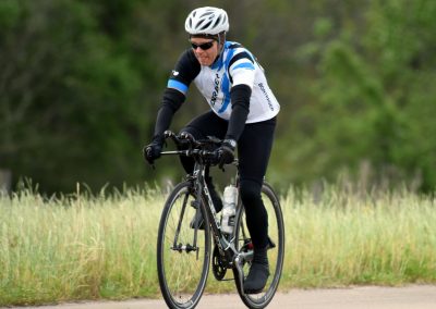 High-performance cyclist riding a bike on a scenic outdoor trail.