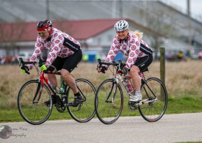 Brightly dressed cyclists riding on a scenic trail during the Bluebonnet Express event.