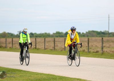 Comfortable cycling on outdoor bike trail with two riders in bright weather.