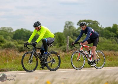 Multisport cyclists riding on a scenic outdoor trail, promoting Bluebonnet Express cycling tours.