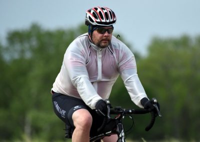 Comfortable cyclist riding on outdoor trail in athletic gear.