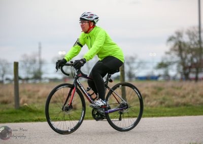 Bright neon green cycling jacket on male rider during Bluebonnet Express ride, fast and scenic bike ride event.