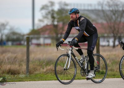 Riders cycling on the Bluebonnet Express route, enjoying scenic outdoor bike riding experience.