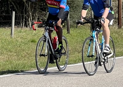 Vibrant cyclists enjoying a scenic ride on the Bluebonnet Express trail with scenic views and active outdoor fun.