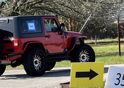 Colorful Jeep parked along road in scenic outdoor setting, showcasing rugged off-road vehicle and natural environment.