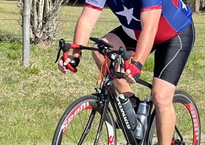 Vibrant cyclist riding a high-performance bike on a scenic outdoor trail.