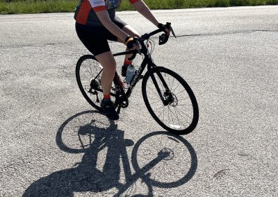 Bright yellow helmet and cycling gear on woman riding a mountain bike outdoors.