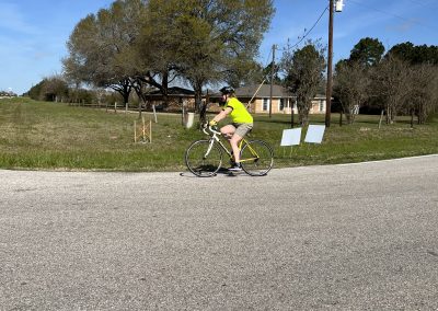 Bike riding on a sunny day with blue skies near suburban homes.