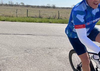Cyclist riding on a rural road in Texas during the Bluebonnet Express event.