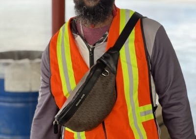Yellow and orange safety vest worn by man at Bluebonnet Express event for improved visibility.