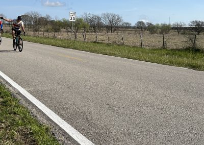 Bike ride along rural highway on a sunny day with clear blue sky.