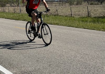 Rider enjoying a sunny bike ride on the Bluebonnet Express route, promoting outdoor cycling and Texas scenic views.