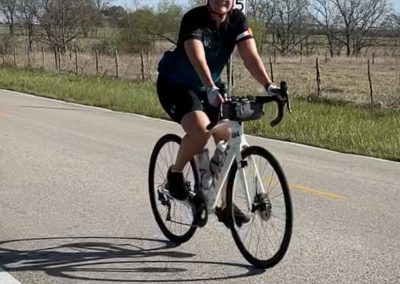Bright cyclist on the Bluebonnet Express bike route enjoying scenic Texas countryside.