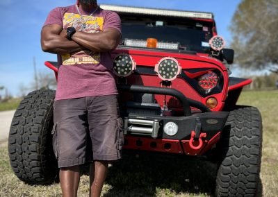 Off-road Jeep with custom lights and equipment, outdoor adventure, rugged vehicle, outdoor exploration, Red Jeep Off-road Vehicle.