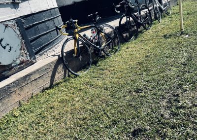 Modern bikes parked against an industrial wall, promoting eco-friendly transportation options from Bluebonnet Express.