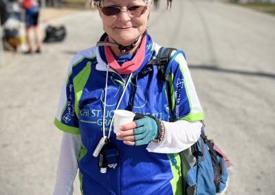 Bike race participant wearing helmet, cycling jersey, and sunglasses at Bluebonnet Express event.