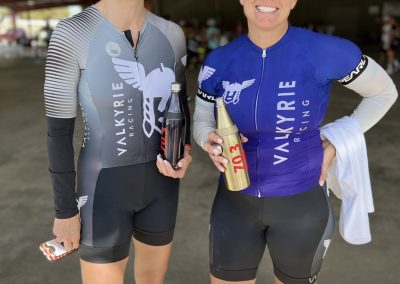 Bright female cyclists in Valkyrie Racing gear at Bluebonnet Express, showing team spirit and athletic excellence.