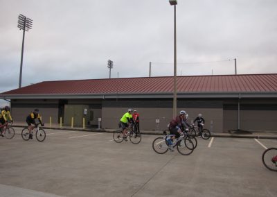 Cyclists riding near Bluebonnet Express stadium at a bike event.