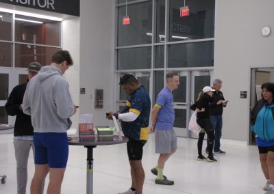 Elevated view of passengers at Bluebonnet Express bus terminal, showcasing modern facility and diverse travelers.