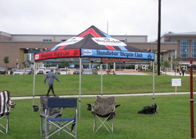 Colorful Handlebar Bicycle Club tent at Bluebonnet Express event.