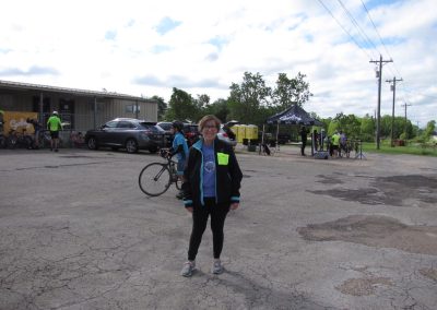 Bicycle event at Bluebonnet Express with cyclists and organizers outdoors in a parking lot.