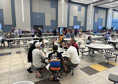 Bright, modern indoor dining area at Bluebonnet Express with diverse group of people enjoying meals.